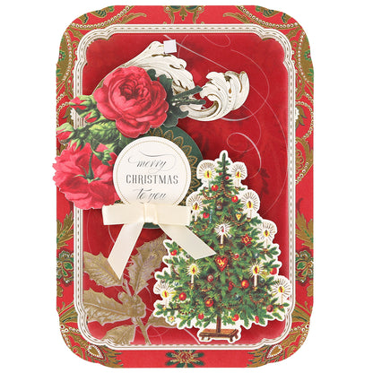 The Simply Merry Christmas Card Making Kit features a red card with gold borders, a Christmas tree, red roses, and “Merry Christmas to you” text—ideal for holiday crafting.
