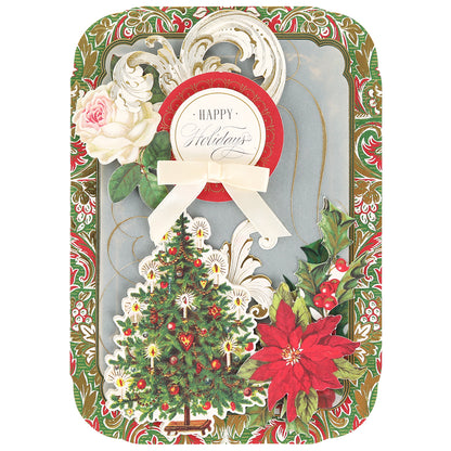 Send warm wishes with the Simply Merry Christmas Card Making Kit featuring festive cards adorned with a Christmas tree, poinsettia, roses, holly, and “Happy Holidays.”.
