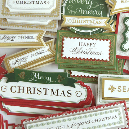 Favorite Christmas Sentiment Stickers from our Christmas sticker library, showcasing assorted festive designs and cheerful greetings like “Merry Christmas,” “Happy Christmas,” and “Joyous Noel,” arranged on a flat surface.