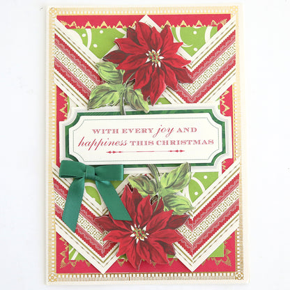 Christmas card featuring vibrant red poinsettias, a green ribbon, and the message “With every joy and happiness this Christmas” set against a festive red, green, and gold chevron background. Enhance your holiday greetings by adding Favorite Christmas Sentiment Stickers for an extra cheerful and personalized touch.