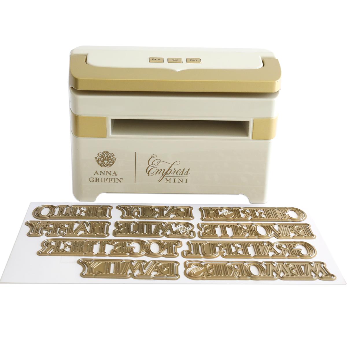 The Empress Mini Machine with Title Dies is shown, featuring a compact design and several gold metal title dies displayed in front.