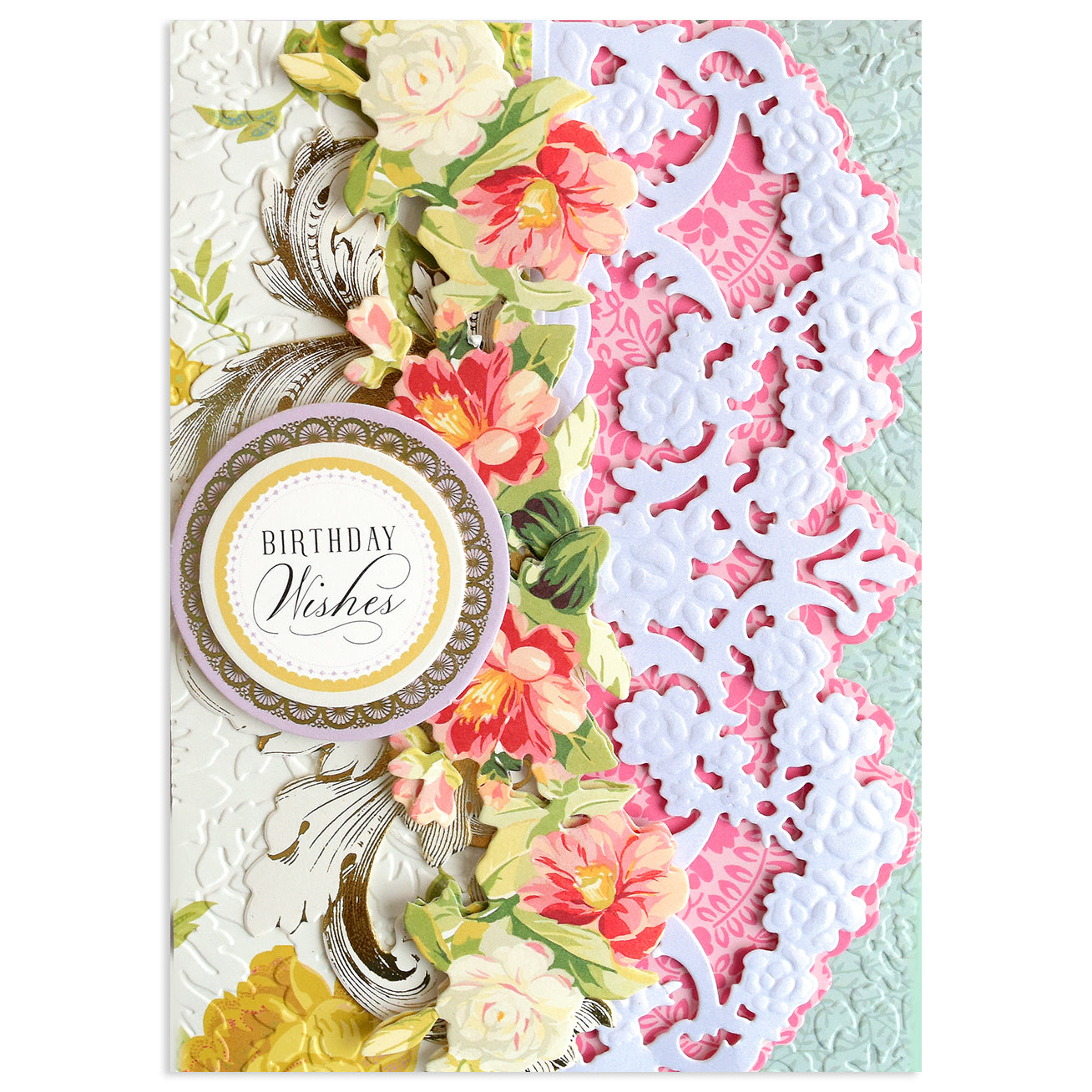 A decorative birthday card with floral designs, ornate white lace patterns made using Opulent Border Cut and Emboss Dies, and a circular label reading "Birthday Wishes.