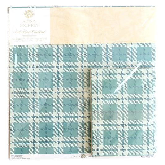 The Fall Plaid 5x7 and 12x12 Cardstock in blue and white, branded by Anna Griffin, captures cozy autumn trends with its packaging display.