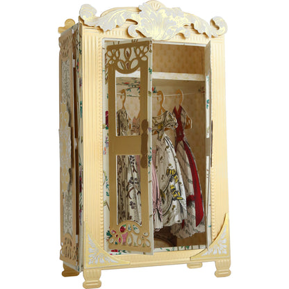 An ornate gold dresser adorned with clothes, perfect for crafting projects or displaying Anna Griffin Antique Armoire Class Materials and Dies on greeting cards.