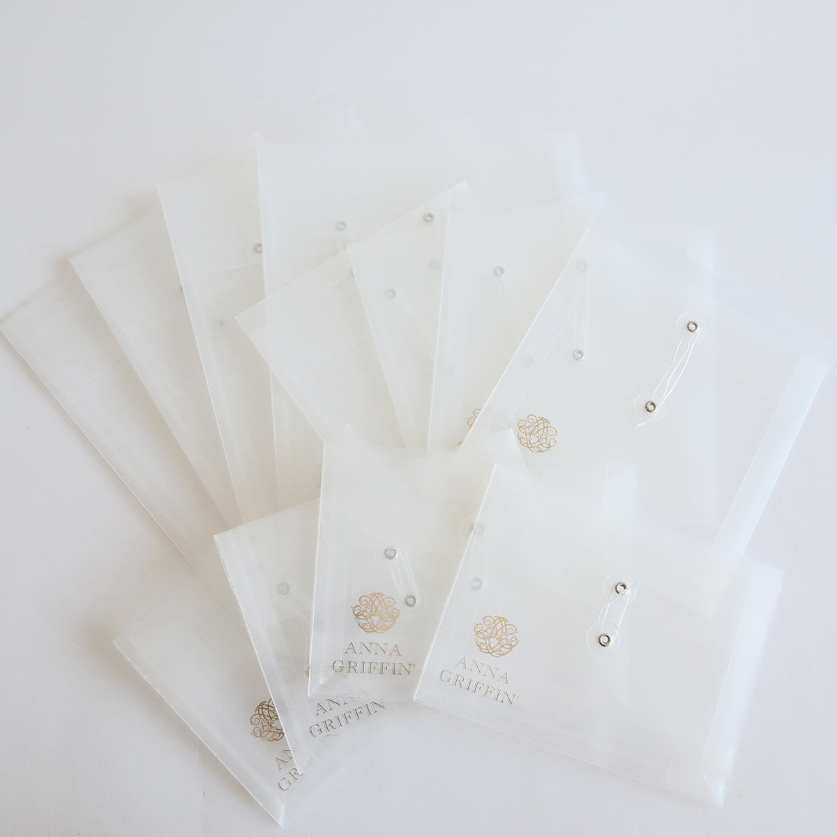Anna Griffin Assorted Pouch Storage 12 count, A group of white envelopes with a gold logo on them.