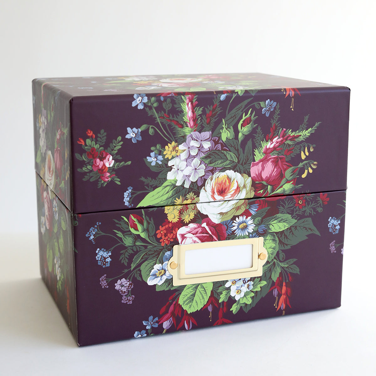 A purple box with a floral design on it. Featuring an Anna Griffin design, this Die Storage Box - Astrid Floral Pattern is the perfect option for organizing and storing your magnetic pages.