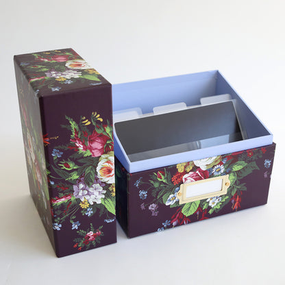 A purple box with a floral design on it, perfect for Die Storage Box - Astrid Floral Pattern. Featuring an Anna Griffin design and equipped with a magnetic page.
