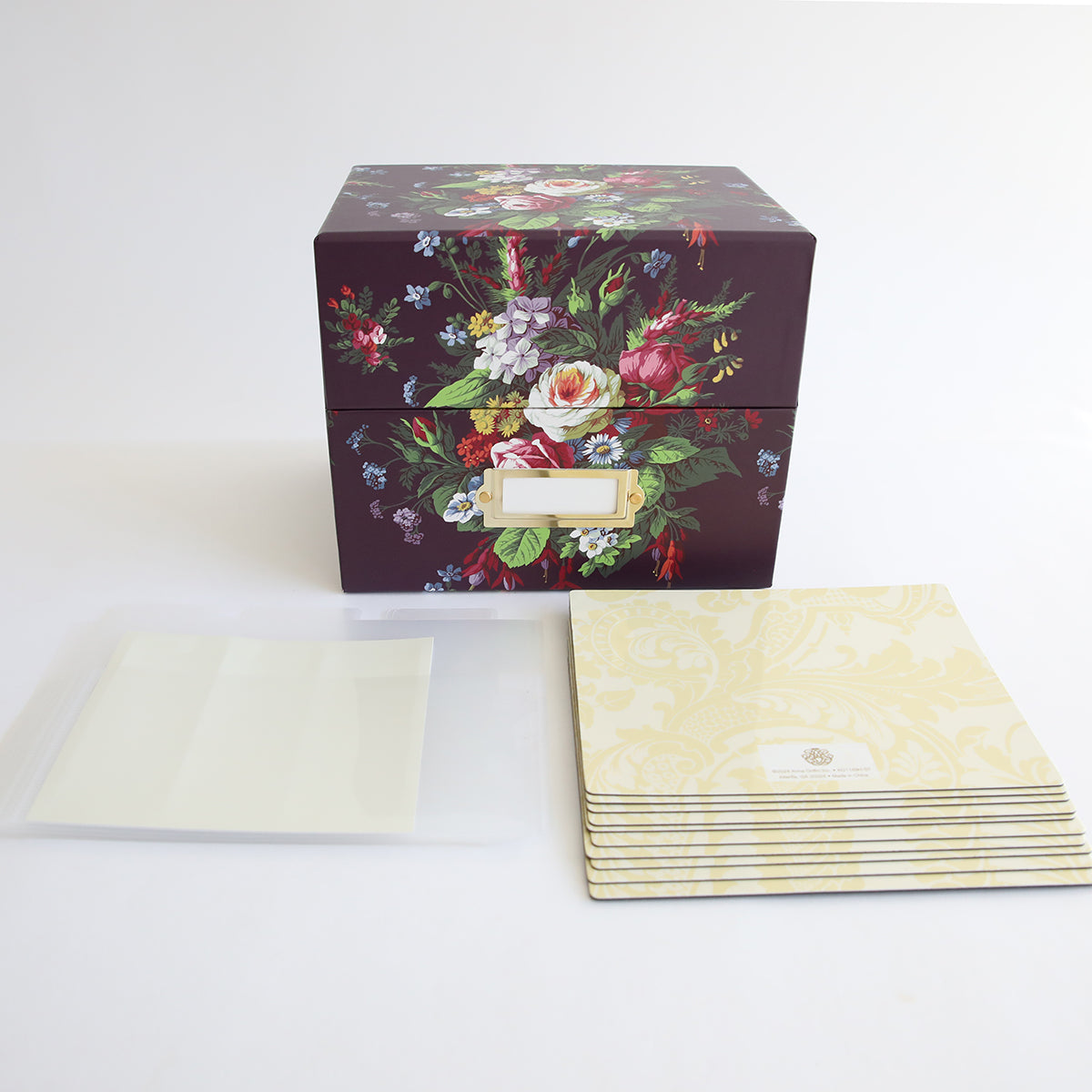 A magnetic page Die Storage Box with an elegant Astrid Floral Pattern design and a set of papers.