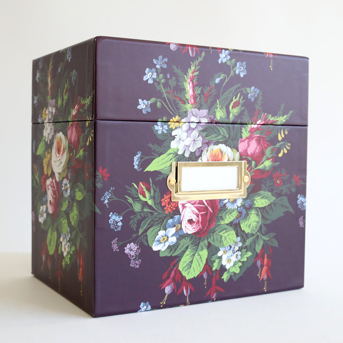 A purple Embossing Folder Storage Box - Astrid with flowers on it.