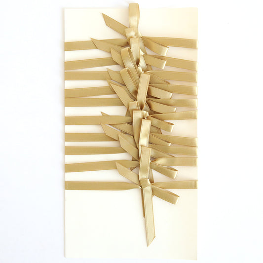 A set of 10 cream-colored cards, each adorned with gold ribbon in a zigzag pattern and finished with double-faced gold satin bows down the center. Product: Gold Satin Bows 10 count.