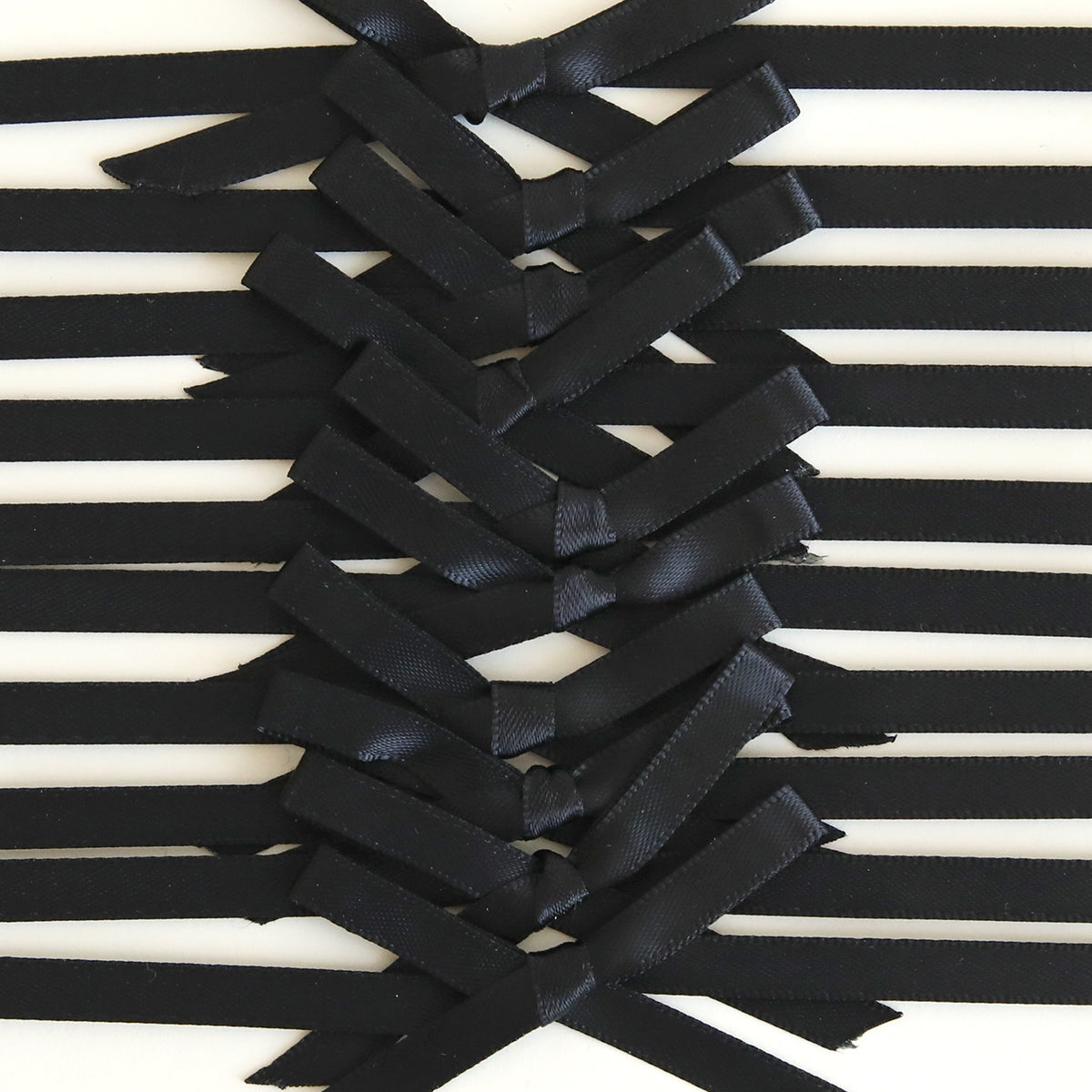 Close-up of Black Satin Bows 10 count, arranged in a crisscross pattern with black ribbons on a white background—perfect for handmade cards.