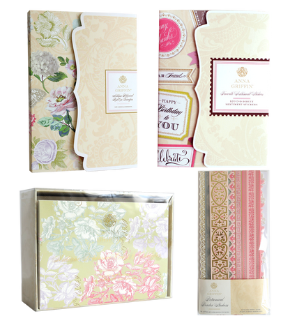 Four decorative stationery sets are displayed, each featuring the Beautiful Botanical Bundle’s floral and ornate patterns in soft pastel tones. The sets are packaged in clear boxes with elegant, vintage-inspired labels on the front. Perfect for layered card making or elevating your collection, these sets also pair beautifully with antique botanical rub-on transfers, allowing you to craft charming, handcrafted pieces.