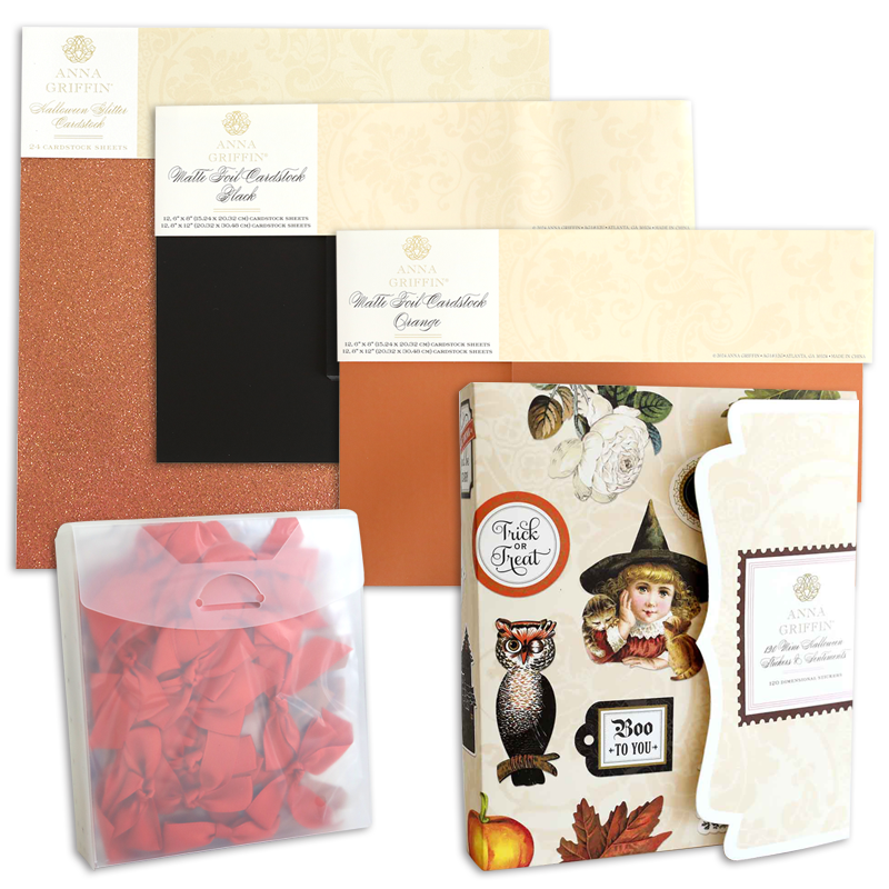 Four packs of Anna Griffin glitter cardstock sheets in assorted colors and textures, a transparent pouch with red ribbons, and a Halloween-themed greeting card kit with festive stickers are all included in the Haunted Halloween Haul—perfect for your spooky crafting adventures.
