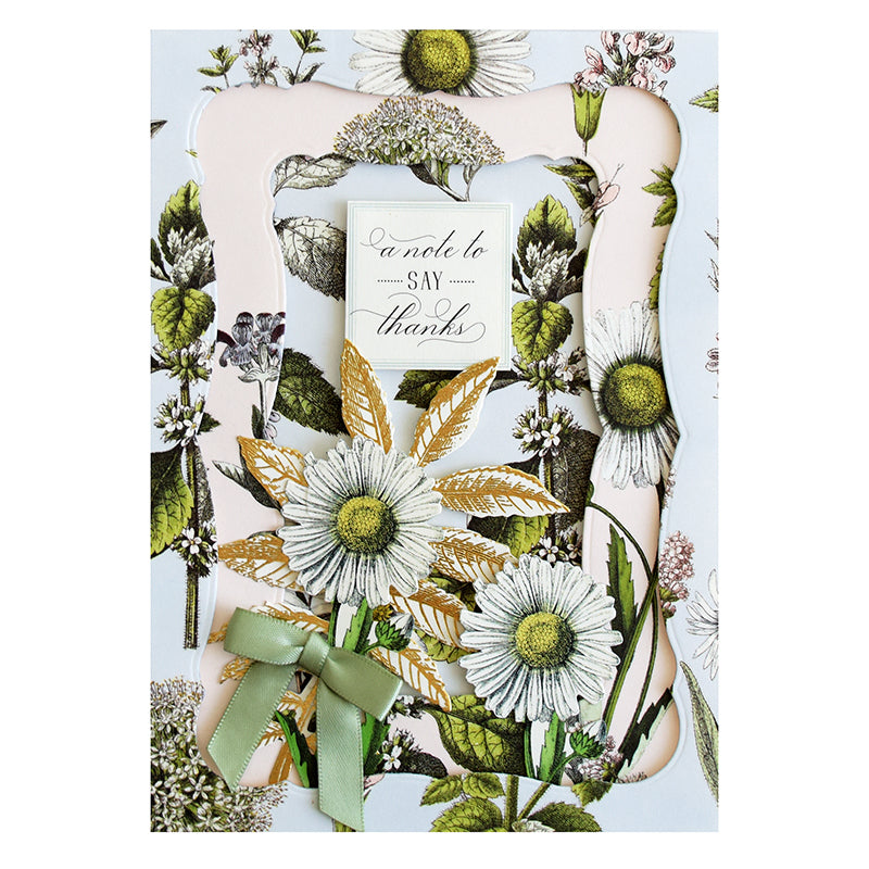 Introducing the Botanical 12x12 Cardstock, meticulously crafted into a thank-you card adorned with elegant botanical illustrations of white daisies, green leaves, and complemented by a charming green bow. It beautifully features the message "A note to say thanks" on the front.