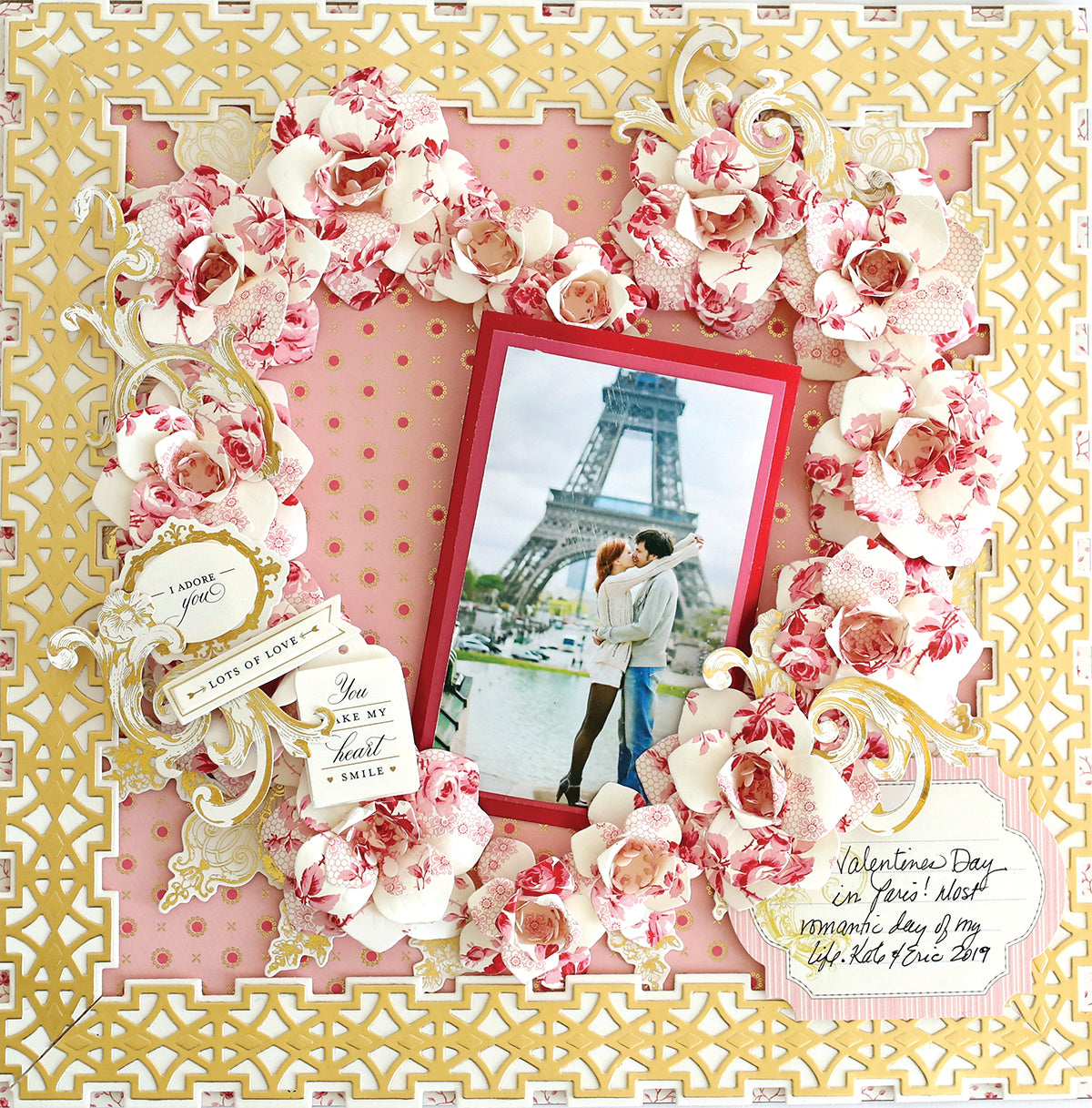 A decorative scrapbook page featuring a central photo of a couple kissing in front of the Eiffel Tower, surrounded by ornate floral and lace designs, with a Valentine's Day theme, perfect for showcasing your Crop at Home II Swag.