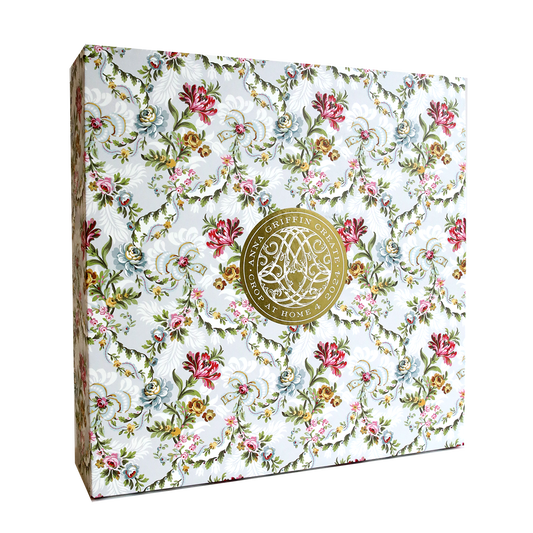 The Crop at Home 4 Scrapbook Collection includes a decorative box crafted from premium cardstock, adorned with a floral pattern and highlighted by a gold circular emblem at the center.