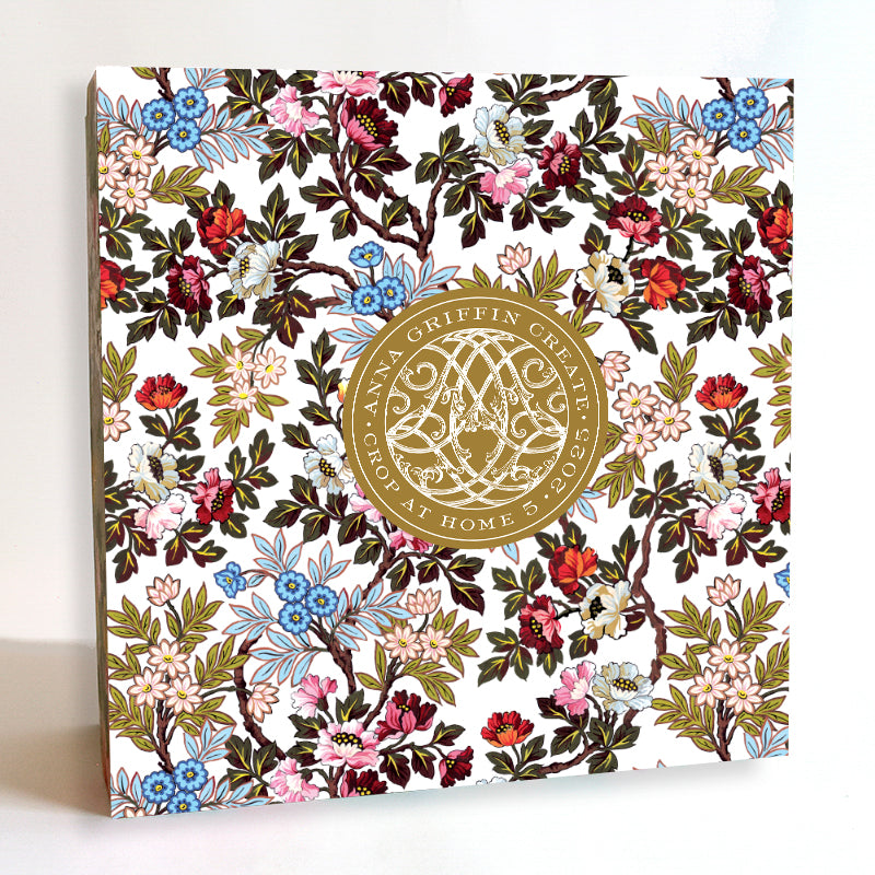 A square box adorned with a floral pattern and a gold emblem that reads "Create Crop At Home 5 Papercraft and Scrapbook Event" invites you to dive into the ultimate scrapbooking experience.