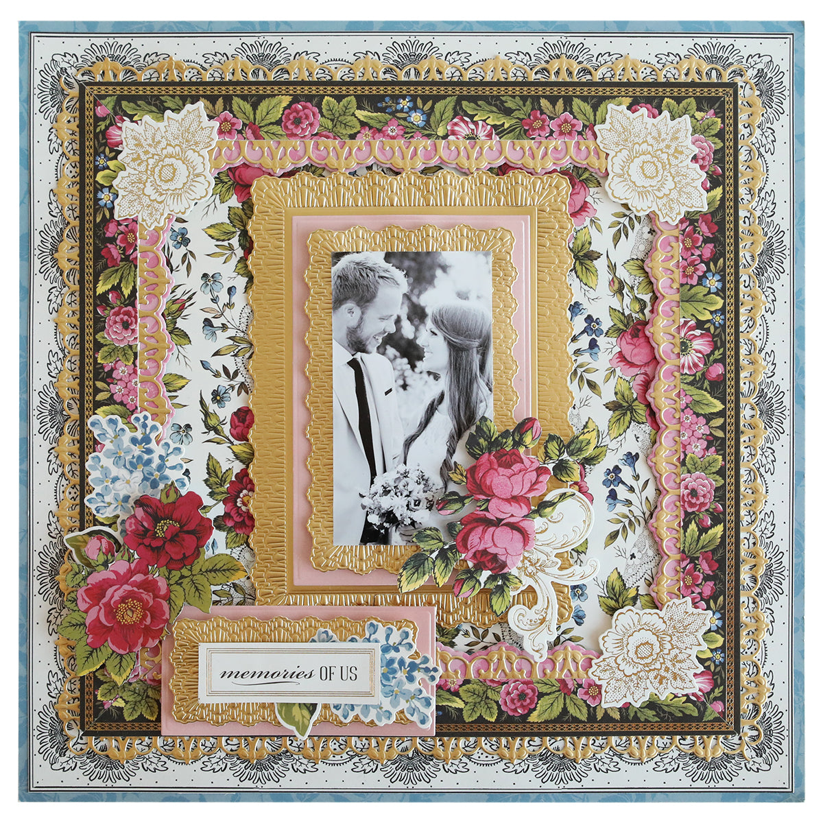 A floral-themed scrapbook page with a central black-and-white photo of a couple, surrounded by layered decorative paper and floral embellishments. A ribbon-edged frame completes the look, and a label reads "memories OF US" using 3D Ribbon Frame Dies.