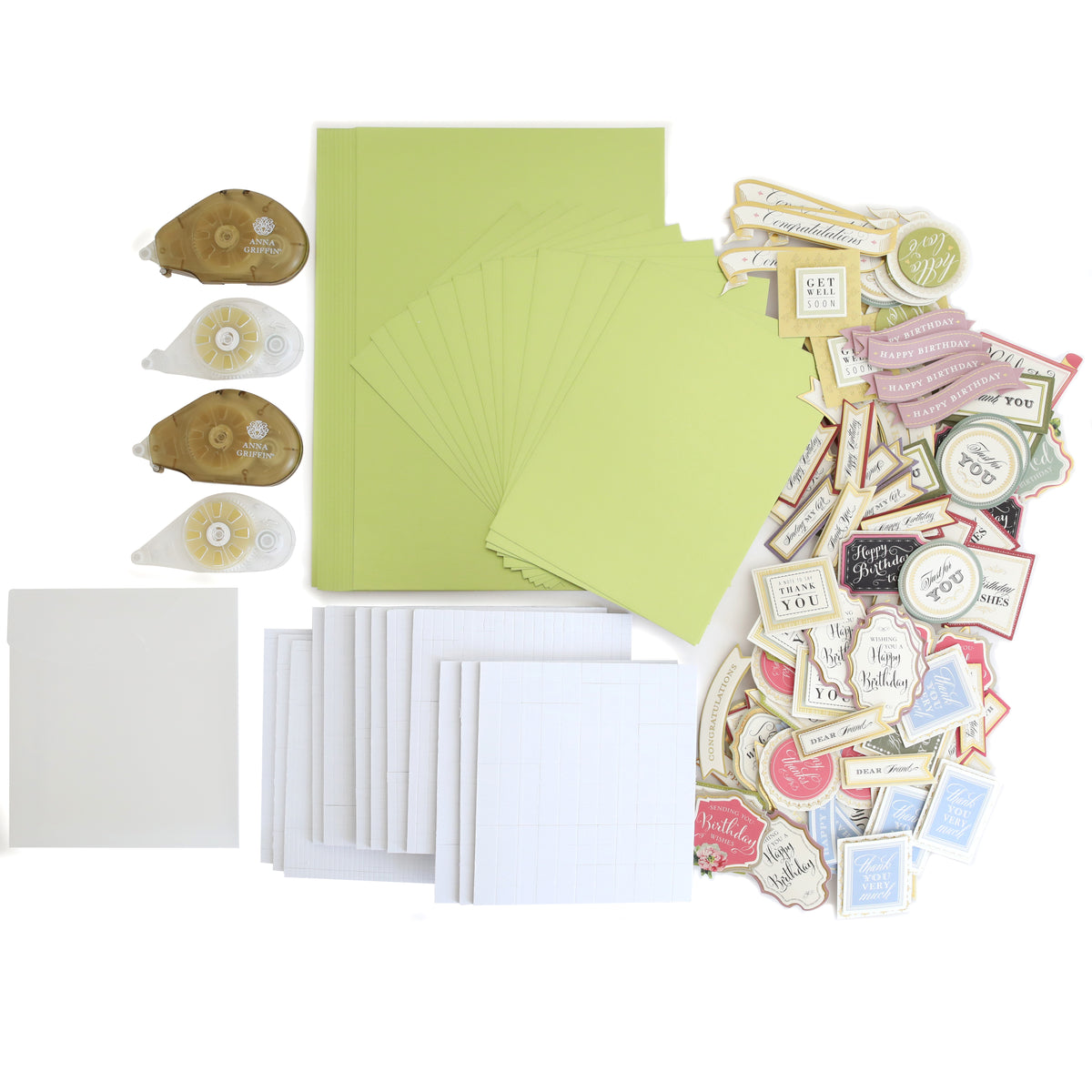 The Create Supply Box includes green cards, white envelopes, adhesive rollers, grid papers, Matte Foil Cardstock, and assorted stickers—everything you need for event supplies—neatly arranged on a white surface.