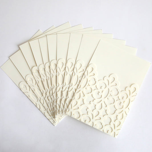 The Ivory Medallion Diecut Pocket 10 pack features elegant cream-colored cards with intricate floral cut-out designs and white diecut medallion pockets, beautifully arranged in a fan shape on a white background.