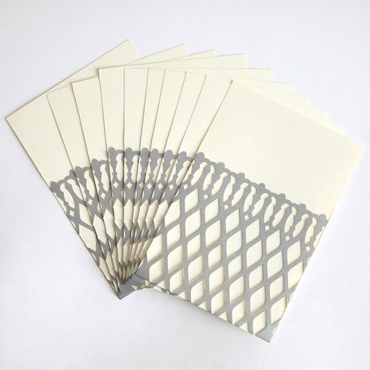 The Silver Trellis Diecut Pocket 10 pack features cream envelopes with silver trellis lattice cutouts, fanned on a white background. Ideal for DIY weddings or chic invitation pockets.
