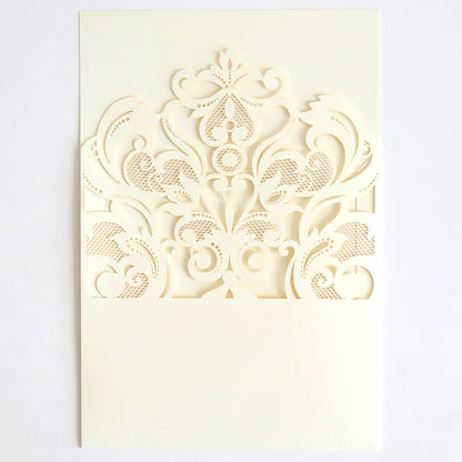 The Ivory Laser Cut Pocket 10 pack features off-white cards with ornate ivory lace laser-cut pockets and scrollwork on the upper half—an elegant choice for decorative wedding invitations.