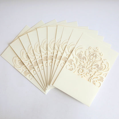 The Ivory Laser Cut Pocket 10 pack features ten cream-colored wedding invitations with ornate ivory lace laser-cut pockets, displayed in a fanned arrangement on a white background.