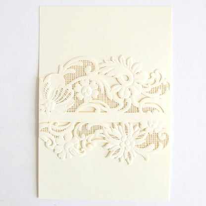 The Ivory Laser Cut Lace Belly Band 10 pack features cream-colored invitations with intricate floral and butterfly cutouts on the front, revealing a textured mesh pattern beneath, elegantly complemented by ivory lace belly bands.