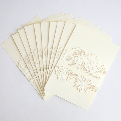 A stack of invitation cards wrapped in Ivory Laser Cut Lace Belly Band (10 pack) is displayed in a fan shape on a white background, showcasing the cream-colored embossed floral designs and elegant lace details.