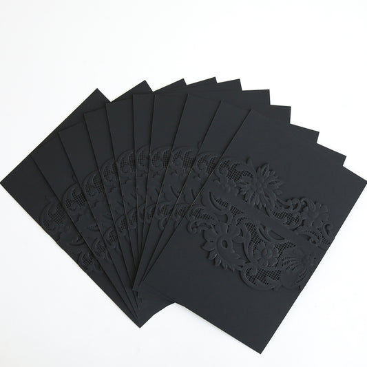 A set of Black Laser Cut Lace Belly Band invitation cards (10 pack) with intricate floral patterns, elegantly displayed on a white background.