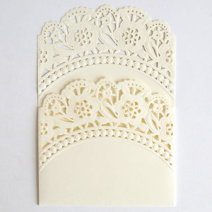 The Ivory Double Scallop Lace Pocket 10 pack features intricately laser-cut, cream-colored holders with scalloped edges and an arched design—ideal for elegantly presenting wedding invitations on a plain white background.