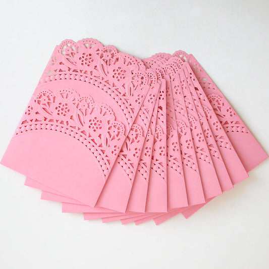 Ten Pink Double Scallop Lace Pocket invitation holders, featuring intricate laser-cut floral and double scallop designs, are fanned out on a white background—perfect for elegant wedding invitations. (10 pack).