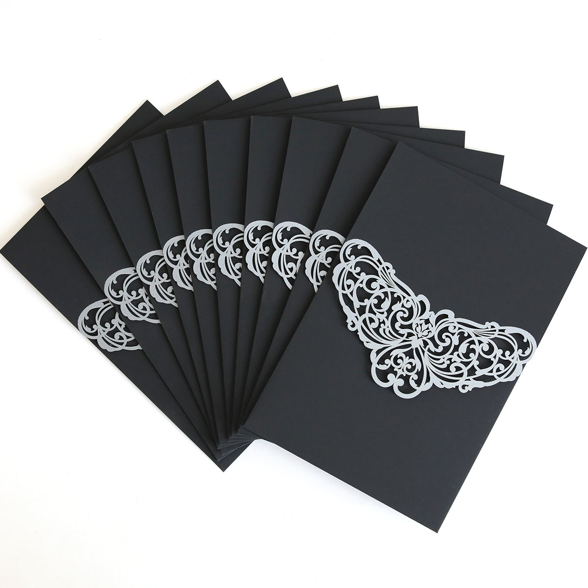 A set of Black Laser Foil Flap Pocket invitations (10 pack) is fanned out on a white surface, highlighting their elegant silver foil ornamental designs.