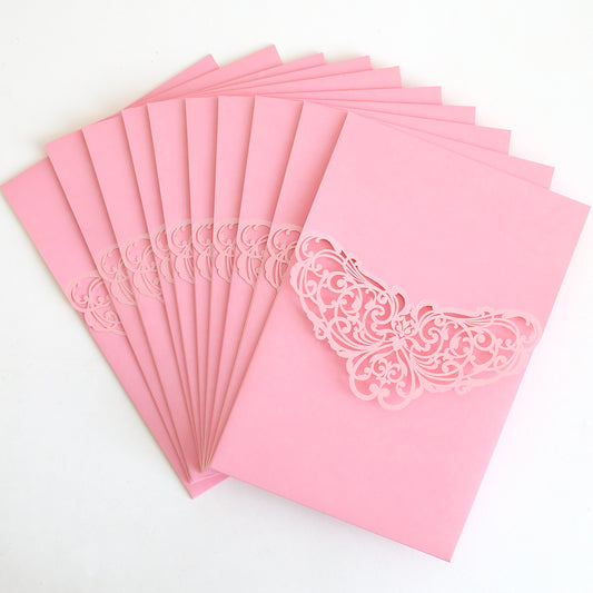 A pack of Pink Laser Foil Flap Pocket invitations is arranged in a fanned-out display on a white surface.