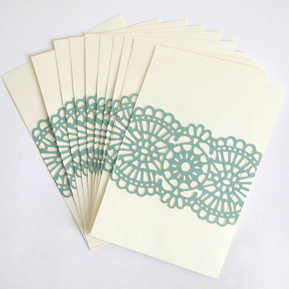 The Blue Green Lace Band 10 pack features cream cards with blue-green lace bands and intricate paper cutout designs, perfect for wedding invitations.