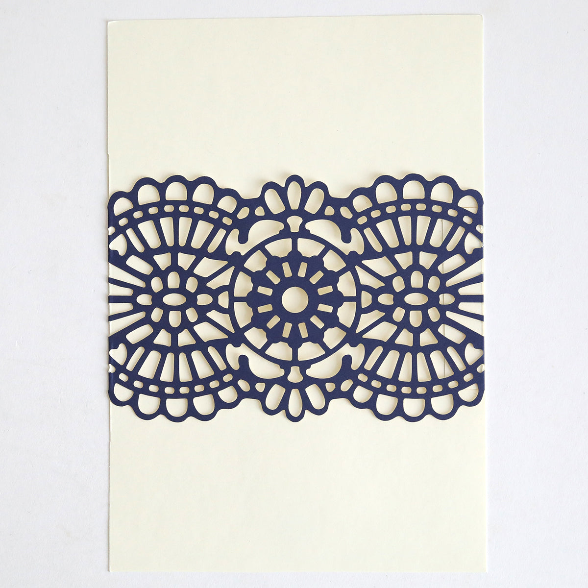 The Navy Lace Band 10 pack features cream cards with an intricate, symmetrical navy blue laser-cut lace pattern, ideal for elegant wedding invitations or adding sophisticated accents to your event stationery.