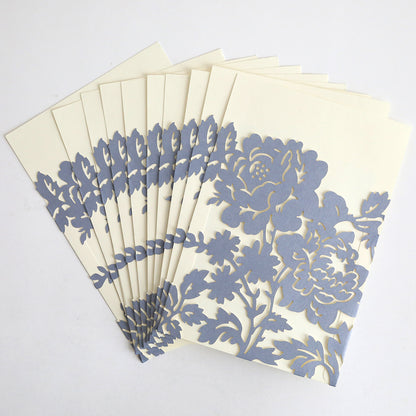 A set of Slate Blue Rose Diecut Pocket cards (10 pack) with cream inserts and intricate silver floral cutout designs is fanned out on a white surface.