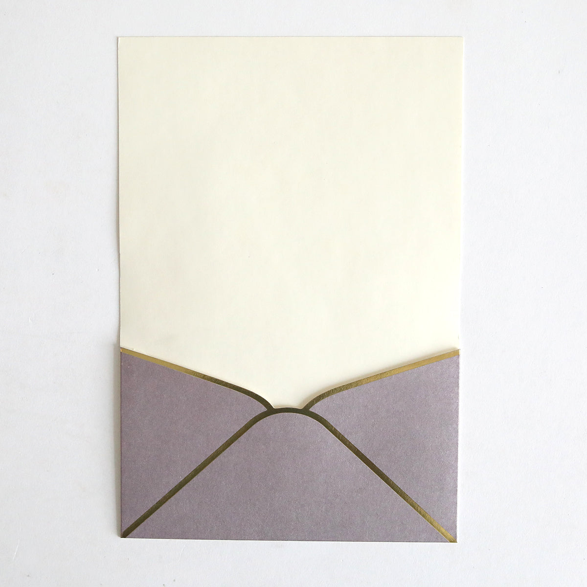 A Lavender Metallic Envelope Pocket from this 10 pack sits open on a plain white surface, revealing a blank cream-colored card inside—ideal for elegant wedding invitations.