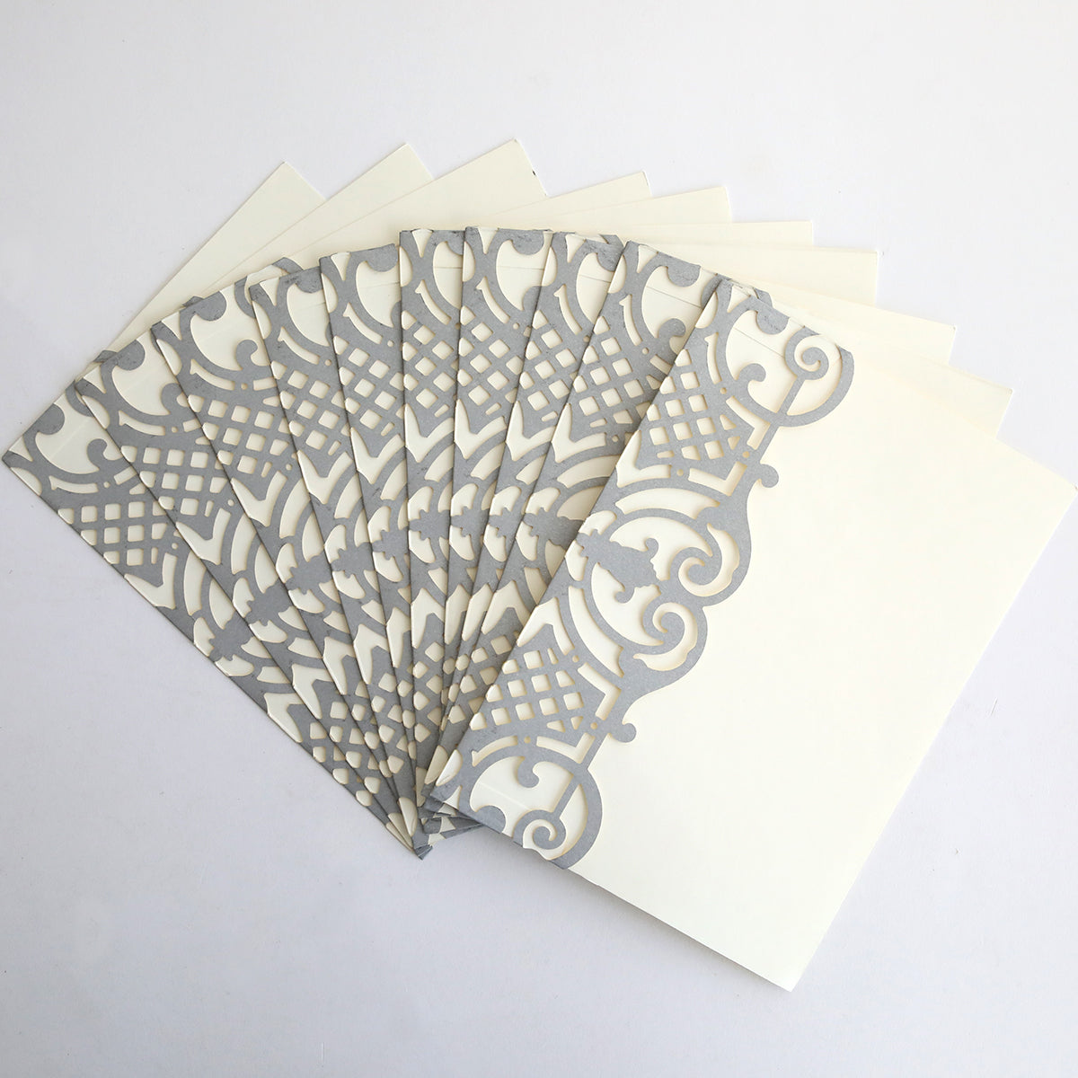 A 10-pack of Silver Diecut Pocket wedding invitations in cream, beautifully arranged in a fan shape on a white background.