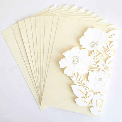 The Floral Diecut Invitation 10 pack includes cream envelopes and matching cards with an ornate white embossed floral cut-out wrap design.