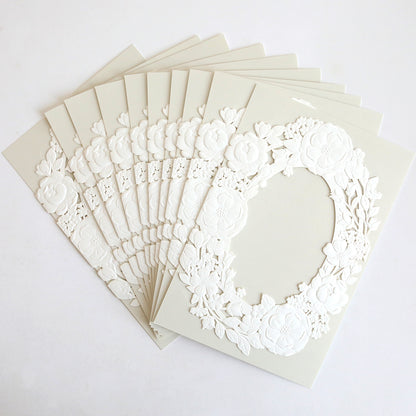 Ten Floral Wreath Laser Cut Invitations (10 pack) are elegantly fanned out, each featuring a delicate floral wreath design—ideal for stylish wedding invitation wraps.