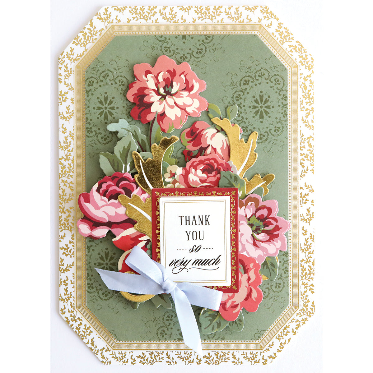 A decorative handmade card featuring pink flowers, gold leaves, a gold border, a blue ribbon, and the heartfelt message “Thank you so very much” in the center—perfect for including in your Simply Gratitude Card Making Kit or enhancing your collection of crafting supplies.