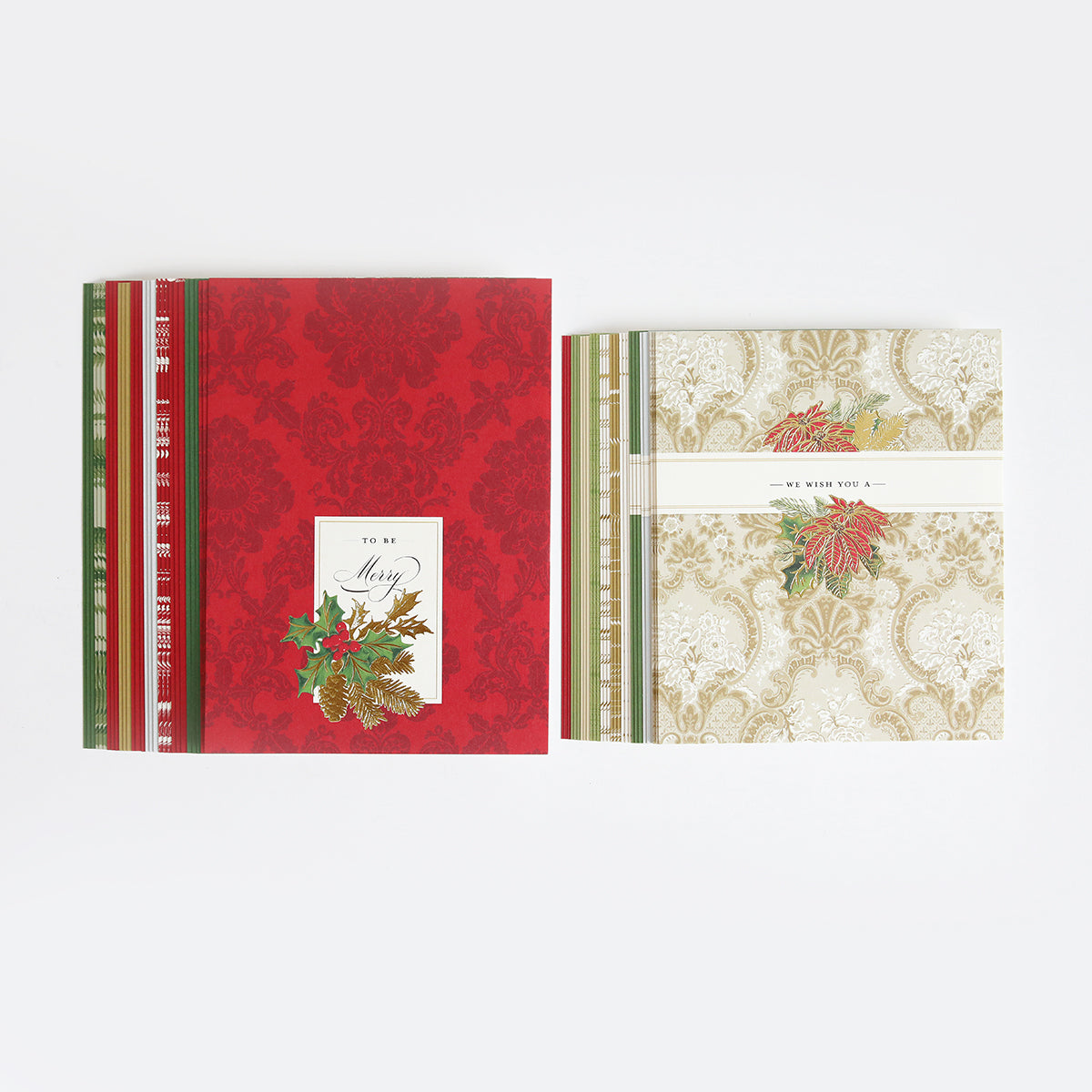 Two sets of holiday cards made from Christmas Clever Sliding Scenes Cardstock are shown: one red with a "Merry" design, the other beige with "We Wish You" text, both featuring festive borders and seasonal foliage accents.