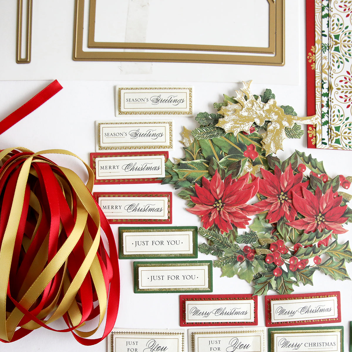 A festive display of table decorations and Anna Griffin Christmas Crackers Class Materials and Dies, accompanied by colorful ribbons.