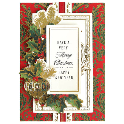 A Christmas Greetings Card Making Kit adorned with ornate red and green holly leaf designs features a heartwarming message that reads, "Have a Very Merry Christmas and a Happy New Year.