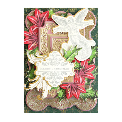 A decorative Christmas card featuring an angel, red poinsettias, holly leaves, and a "Merry Christmas" greeting in metallic ink pads of gold and white with an intricate background design from the Christmas Perfect Palette Inks collection.