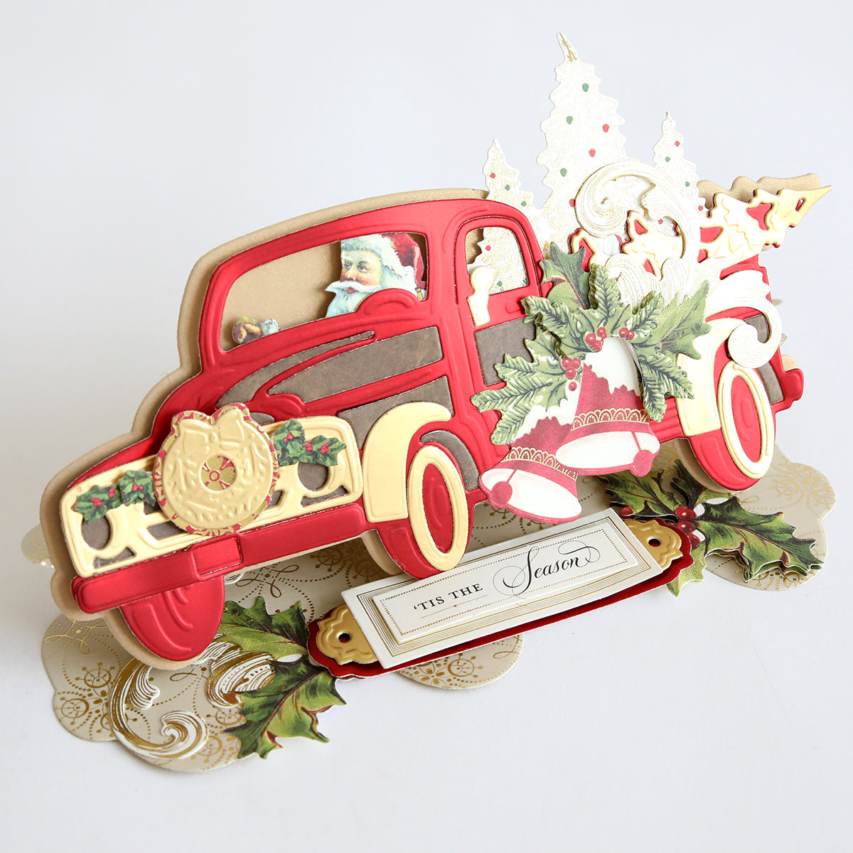 An Anna Griffin Christmas Truck Easel Die featuring a red truck and a Christmas tree.
