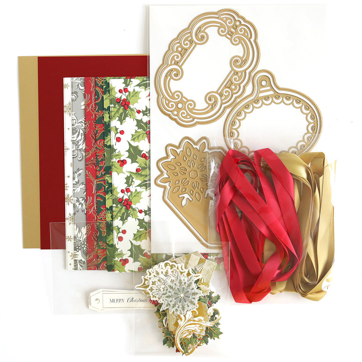 Festive Tags Dies and Materials, offering a variety of Christmas-themed crafting supplies such as patterned paper, satin ribbons, die-cut shapes, and tags with a "Merry Christmas" design.