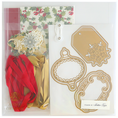 Festive Tags Dies and Materials kit includes holly-themed cardstock, satin red and gold ribbons, decorative cutout designs, and festive metallic tags.