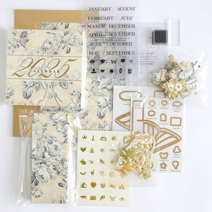 The Creative Calendar Stamps, Dies, and Materials set features a 2025 planner kit with a floral design cover. It includes calendar pages, creative calendar dies, a clear stamp set for months, flower embellishments, gold stickers, and decorative elements on a white background.